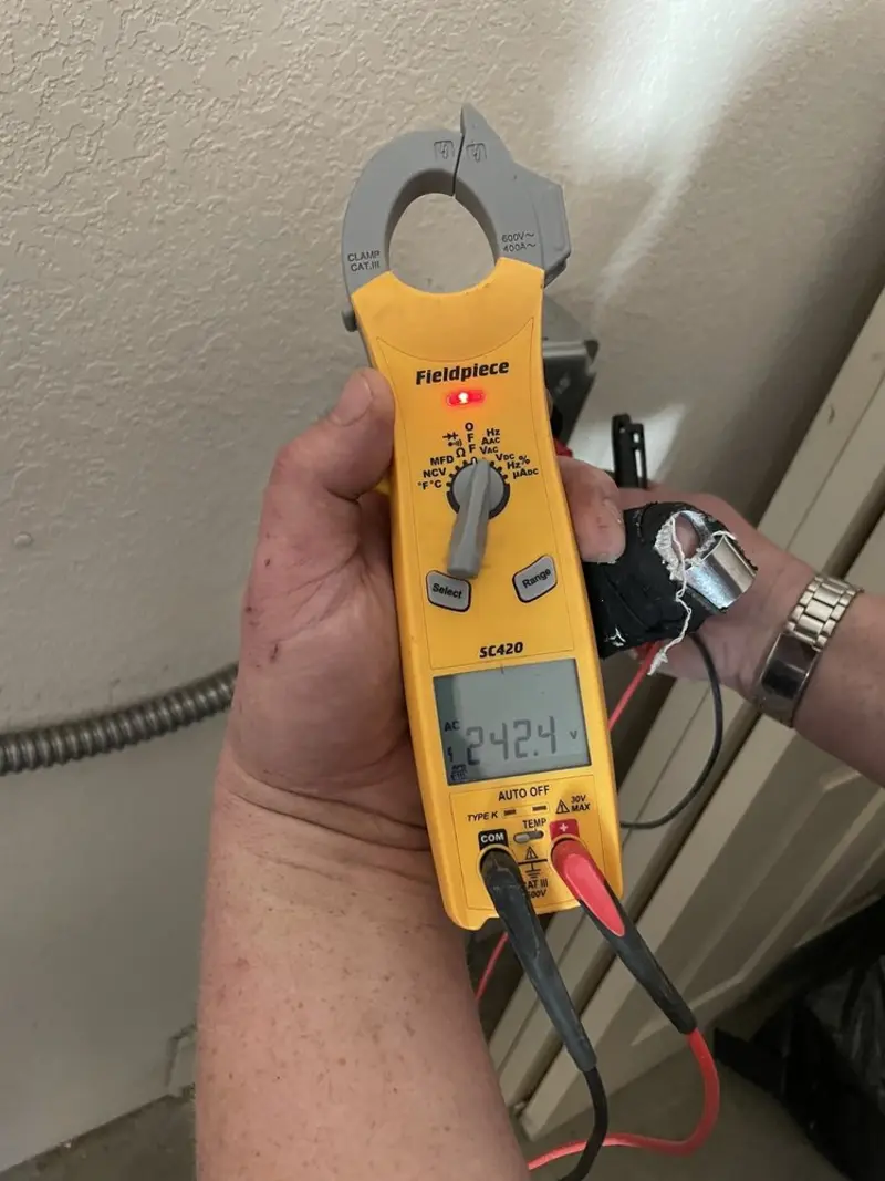 Voltage testing with clamp meter during Electrical Installation Services in Grottoes